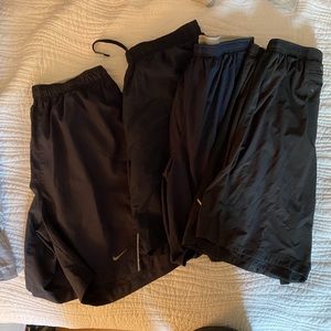 Four pairs of running shorts. 3 Nike, 1 Hanes